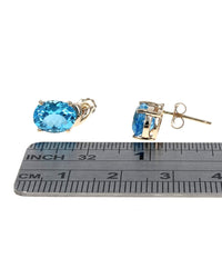 Swiss Blue Topaz Swirl Accent Stud Earrings in Yellow Gold