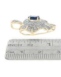 Blue Sapphire and Diamond Halo Heart Pendant in White and Yellow Gold