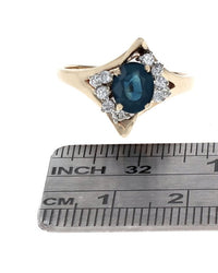Oval Dark Blue Sapphire and Diamond Accent Ring in Yellow Gold