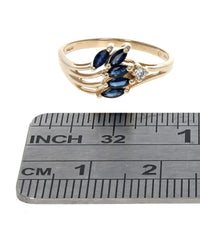 Blue Sapphire and Diamond Accent Wave Ring in Yellow Gold