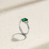 Nouveau Two Tone Three Stone Oval Colombian Emerald and Diamond Ring