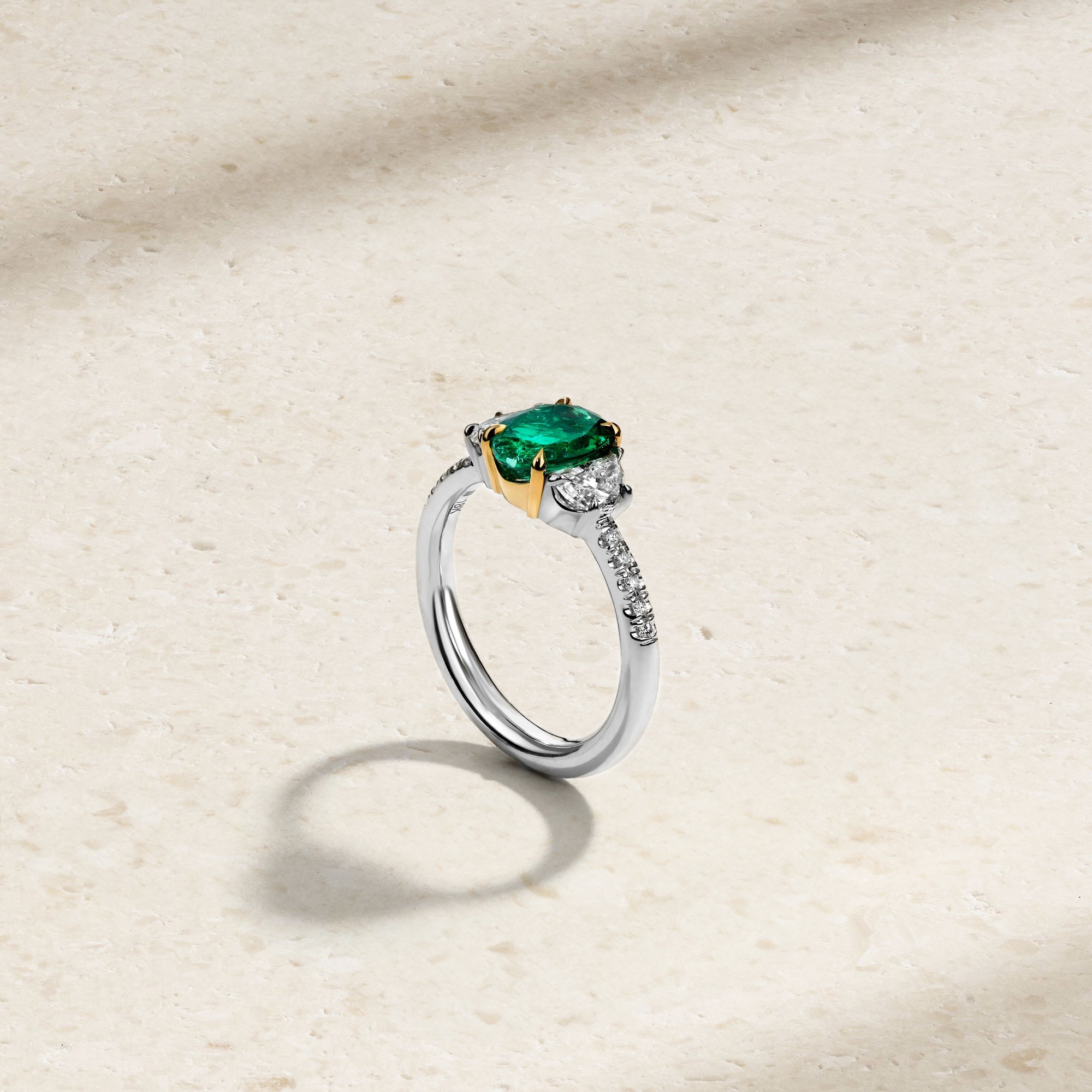 Nouveau Two Tone Three Stone Oval Colombian Emerald and Diamond Ring